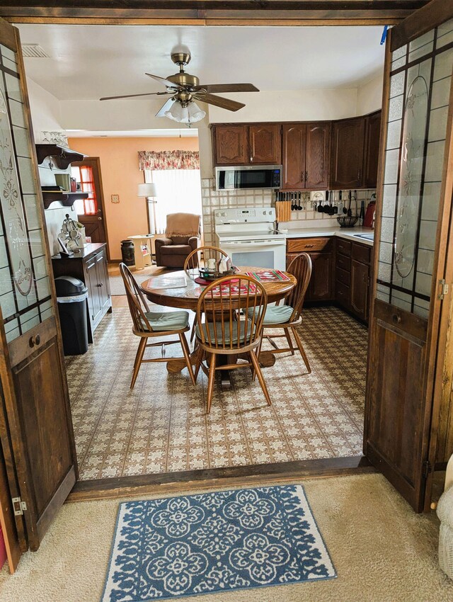 kitchen featuring backsplash, sink, stainless steel appliances, and dark brown cabinetry