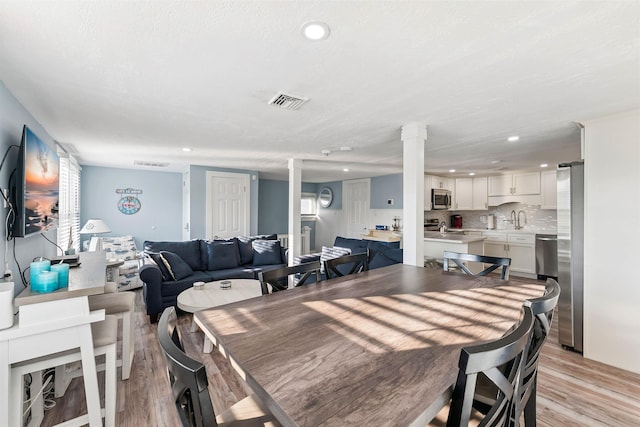 140 E Burk Ave Unit A, Wildwood, NJ 08260 - dining area with light wood-style flooring, decorative columns, recessed lighting, and plenty of natural light