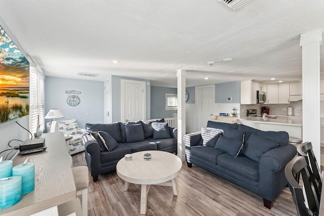 140 E Burk Ave Unit A, Wildwood, NJ 08260 - living area featuring wood finished floors, ornate columns, and recessed lighting