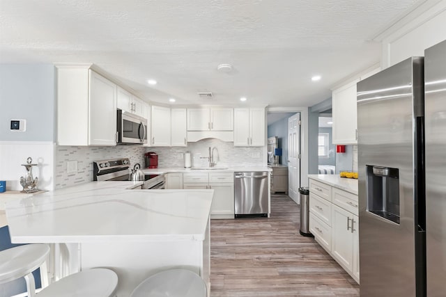 140 E Burk Ave Unit A, Wildwood, NJ 08260 - kitchen with stainless steel appliances, light countertops, a peninsula, light wood-style flooring, and recessed lighting
