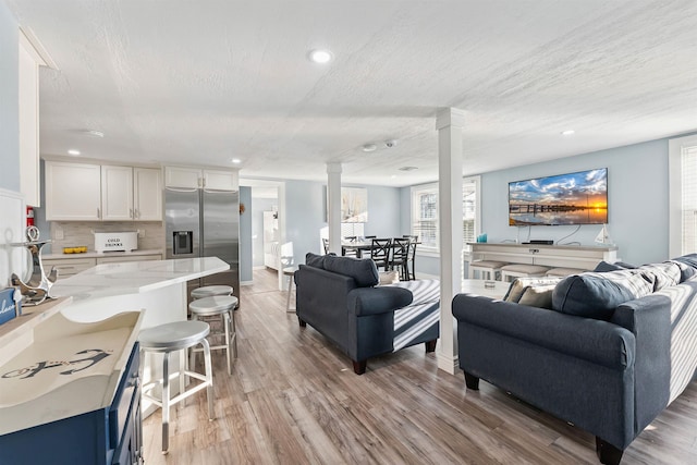 140 E Burk Ave Unit A, Wildwood, NJ 08260 - living room featuring ornate columns, light wood-type flooring, recessed lighting, and a textured ceiling