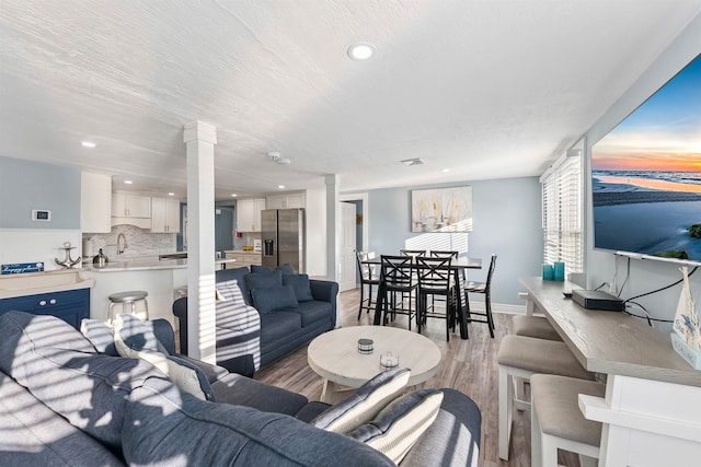140 E Burk Ave Unit A, Wildwood, NJ 08260 - living area featuring ornate columns, light wood-type flooring, and recessed lighting