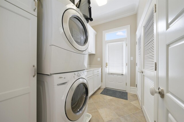 261 45th St, Avalon, NJ 08202 - laundry area featuring stacked washer / dryer, cabinet space, crown molding, and light tile patterned floors