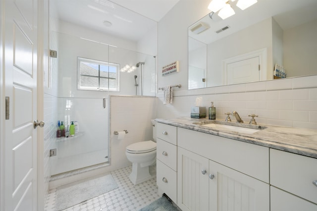 261 45th St, Avalon, NJ 08202 - bathroom with a stall shower, vanity, tile walls, and tile patterned floors
