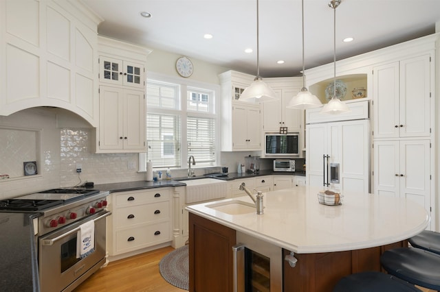 261 45th St, Avalon, NJ 08202 - kitchen featuring built in appliances, a breakfast bar area, tasteful backsplash, hanging light fixtures, and recessed lighting