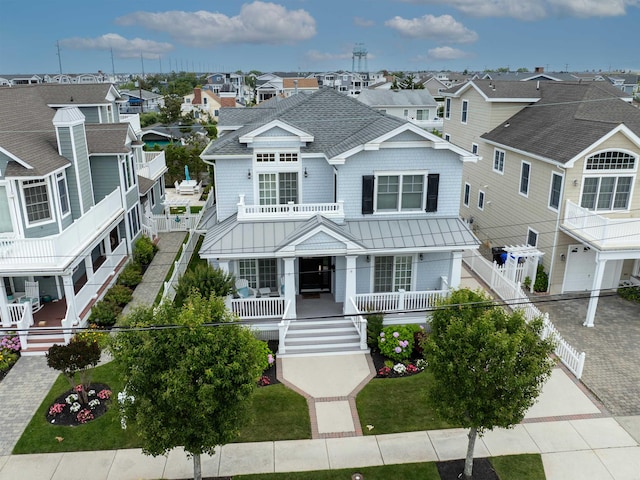 261 45th St, Avalon, NJ 08202 - view of front facade with a residential view, a standing seam roof, stairs, and covered porch