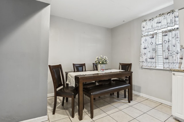 dining area with light tile patterned floors