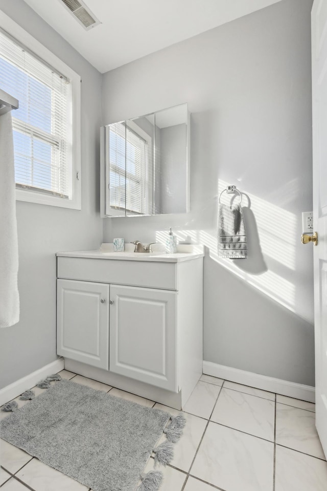 bathroom with vanity, tile patterned floors, and a wealth of natural light