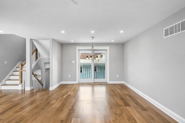 297 24th St Unit 297, Avalon, NJ 08202 - unfurnished dining area featuring wood finished floors, a chandelier, stairway, baseboards, and recessed lighting