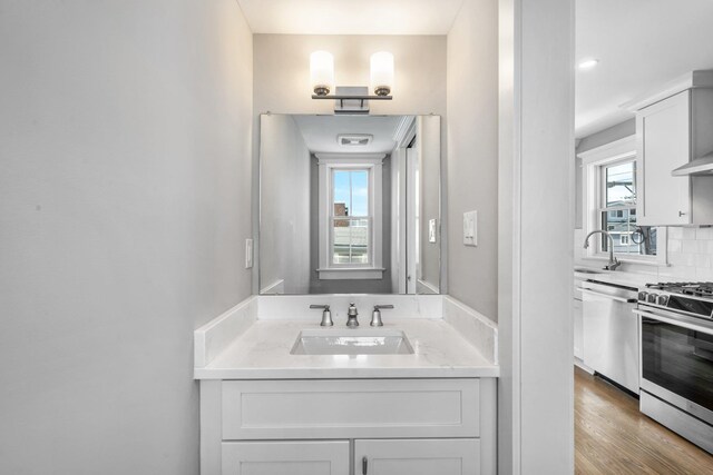 297 24th St Unit 297, Avalon, NJ 08202 - bathroom with decorative backsplash, wood finished floors, and vanity