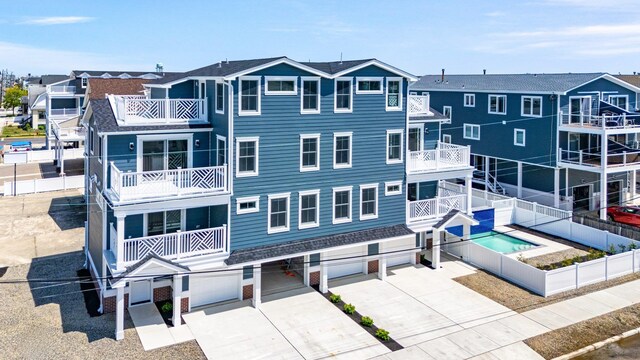 297 24th St Unit 297, Avalon, NJ 08202 - view of property with a garage, concrete driveway, and fence