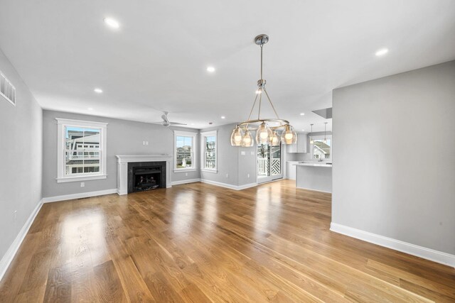297 24th St Unit 297, Avalon, NJ 08202 - unfurnished living room with ceiling fan, baseboards, recessed lighting, a fireplace, and light wood-style flooring