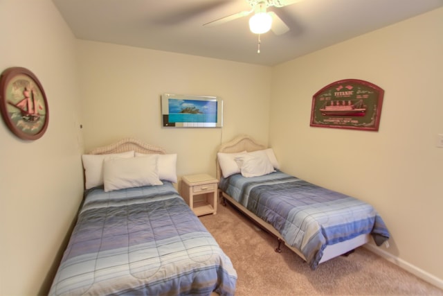 bedroom with ceiling fan and light carpet