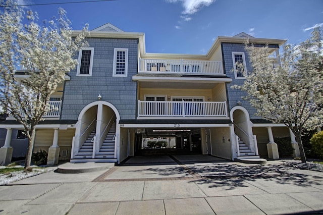 view of front of home with a balcony and a carport