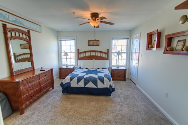 bedroom with light colored carpet and ceiling fan