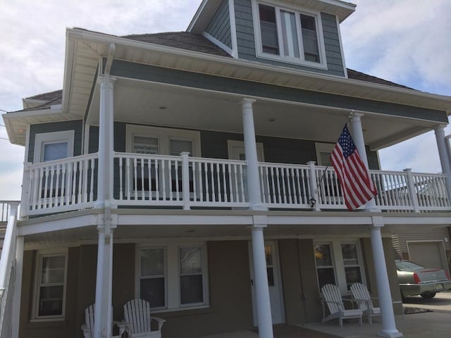 rear view of property featuring a balcony