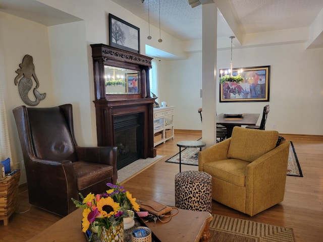 113 W Walnut Ave, North Wildwood, NJ 08260 - living room with a fireplace with flush hearth, wood finished floors, a chandelier, and a textured ceiling