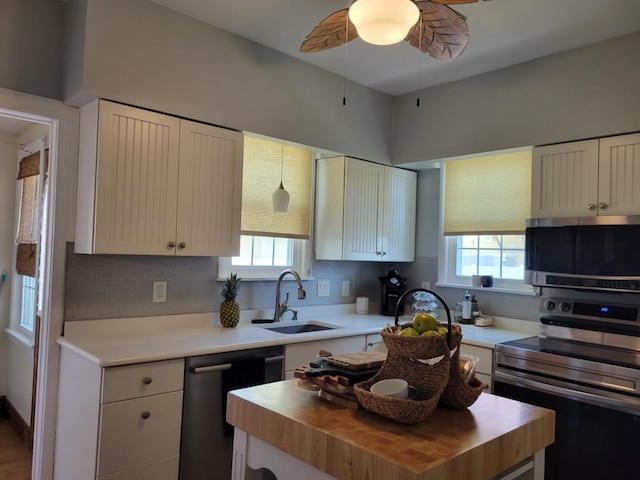 113 W Walnut Ave, North Wildwood, NJ 08260 - kitchen with appliances with stainless steel finishes, wood counters, decorative backsplash, a center island, and white cabinetry