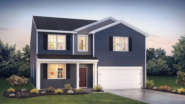 view of front of house featuring a garage and a lawn