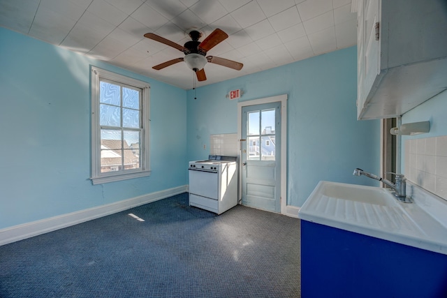 918 Stockton Ave, Cape May, NJ 08204 - interior space featuring dark colored carpet, a sink, range with electric stovetop, and baseboards