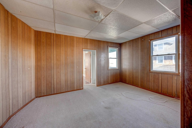 918 Stockton Ave, Cape May, NJ 08204 - empty room with a paneled ceiling, wooden walls, baseboards, and carpet flooring
