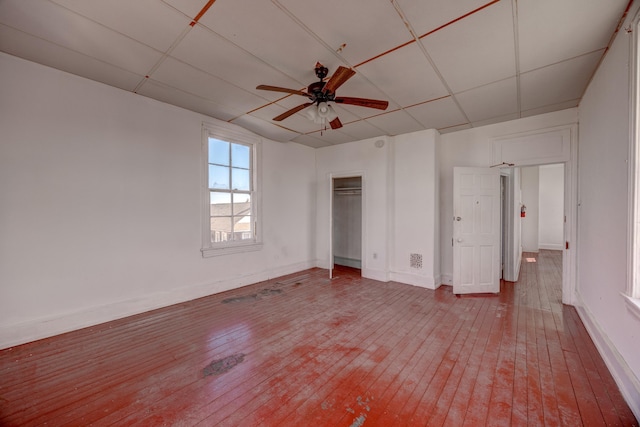 918 Stockton Ave, Cape May, NJ 08204 - unfurnished bedroom with ceiling fan, a paneled ceiling, baseboards, a closet, and wood-type flooring