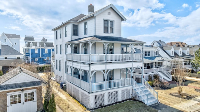 918 Stockton Ave, Cape May, NJ 08204 - view of front of home with a porch, an outdoor structure, stairway, a residential view, and a chimney