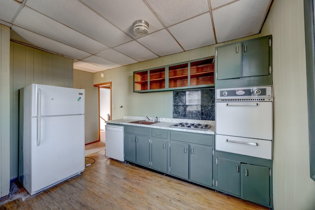 918 Stockton Ave, Cape May, NJ 08204 - kitchen with a warming drawer, open shelves, light wood-style flooring, a sink, and white appliances