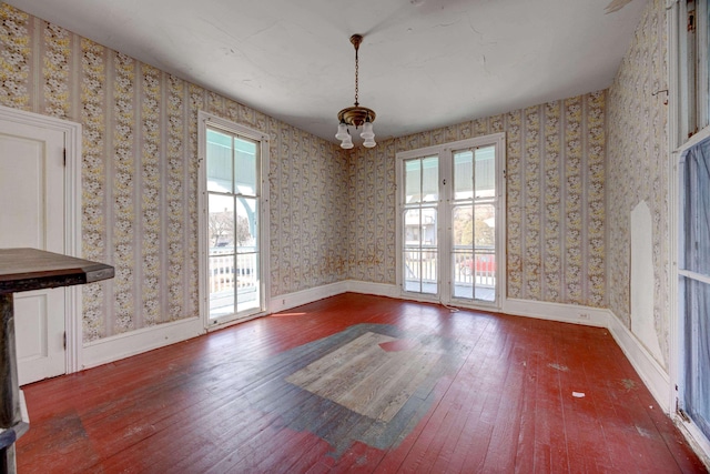 918 Stockton Ave, Cape May, NJ 08204 - unfurnished dining area with baseboards, hardwood / wood-style floors, a chandelier, and wallpapered walls