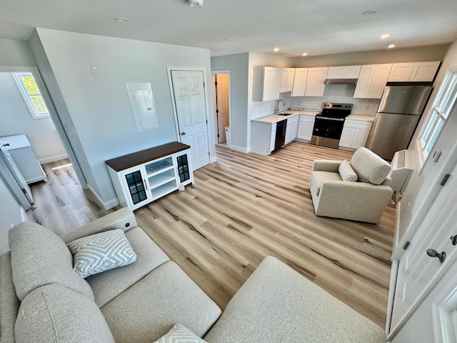 2001 Surf Ave Unit 12, North Wildwood, NJ 08260 - living room featuring recessed lighting, light wood-style flooring, and electric panel