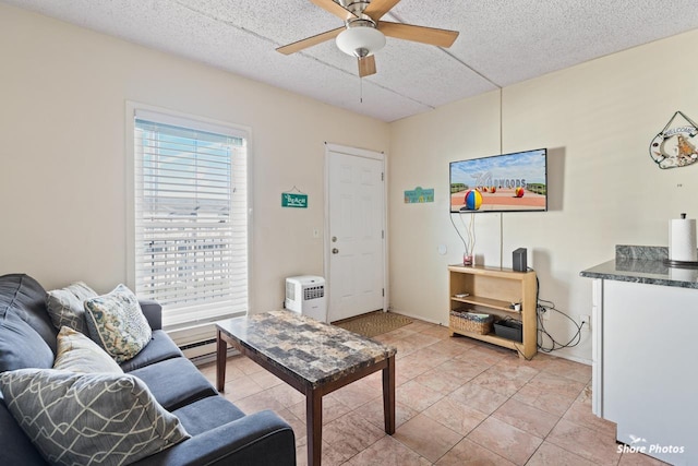 living room with light tile patterned floors, a textured ceiling, ceiling fan, and baseboard heating