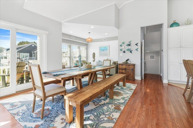 dining space featuring lofted ceiling and dark wood-type flooring