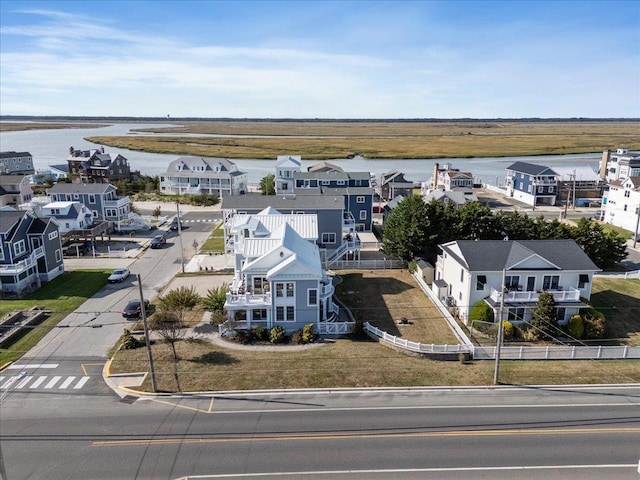 drone / aerial view with a residential view and a water view