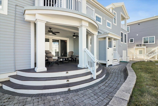 exterior space with ceiling fan and a balcony