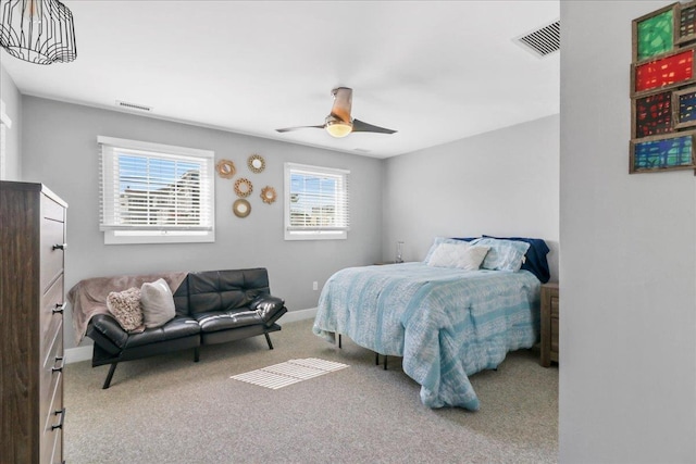 carpeted bedroom with visible vents, ceiling fan, and baseboards