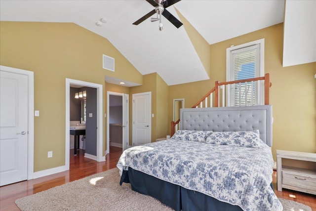 bedroom with lofted ceiling, wood finished floors, a ceiling fan, visible vents, and baseboards