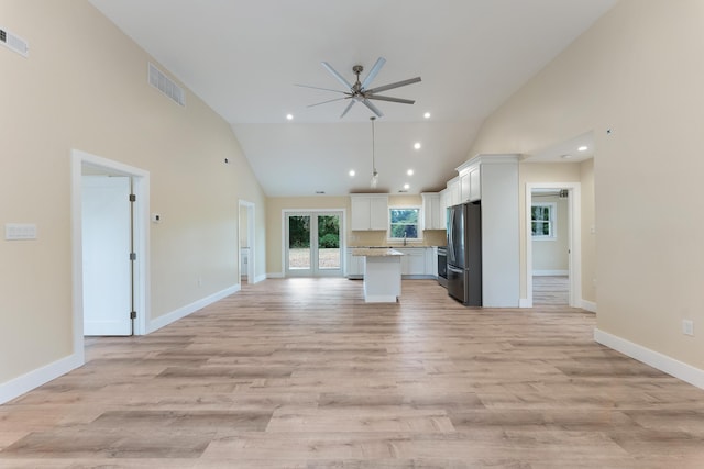 kitchen featuring a center island, white cabinets, ceiling fan, light hardwood / wood-style floors, and stainless steel refrigerator