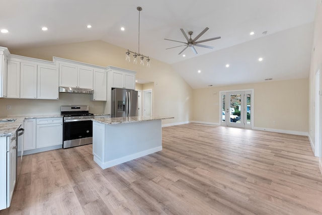 kitchen featuring white cabinetry, ceiling fan, stainless steel appliances, decorative light fixtures, and a kitchen island