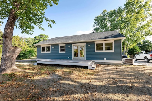back of property with a deck and french doors