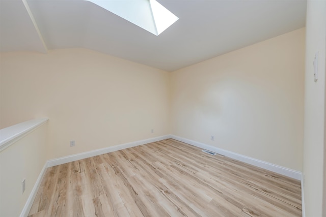 24 Heron Way N, Cape May, NJ 08204 - unfurnished room with a skylight, light wood-style floors, vaulted ceiling, and baseboards
