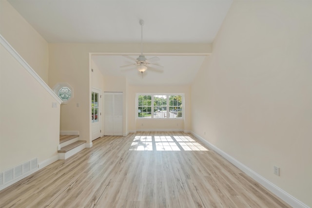 24 Heron Way N, Cape May, NJ 08204 - unfurnished living room with wood finished floors, lofted ceiling, stairway, ceiling fan, and baseboards