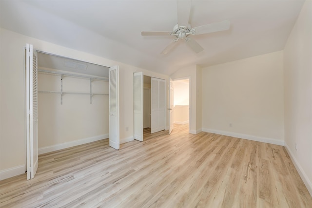 24 Heron Way N, Cape May, NJ 08204 - unfurnished bedroom featuring light wood finished floors, two closets, lofted ceiling, baseboards, and ceiling fan