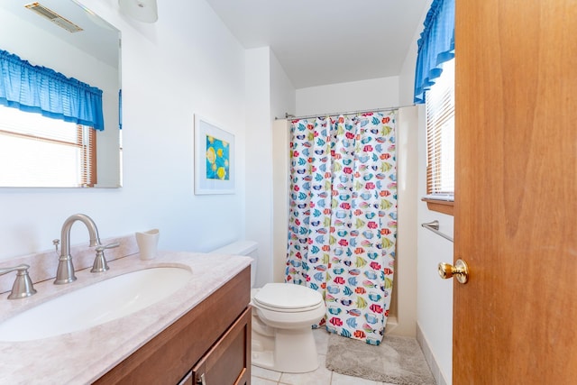 bathroom featuring tile patterned flooring, vanity, toilet, and curtained shower