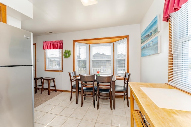 dining space featuring light tile patterned floors