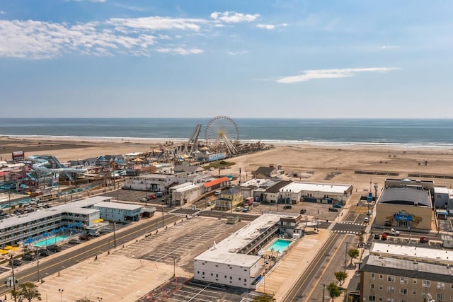 drone / aerial view featuring a view of the beach and a water view