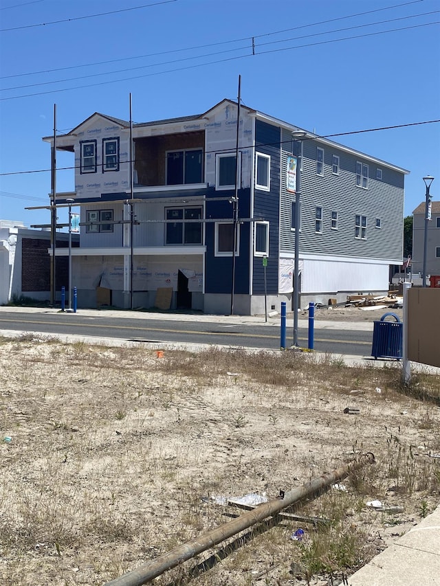 back of house with central AC unit