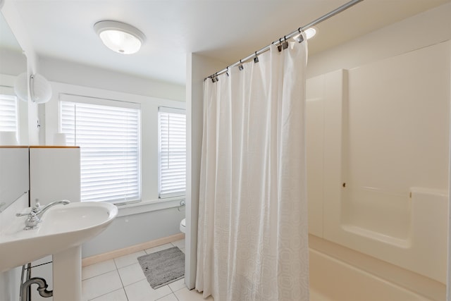 full bathroom featuring tile patterned floors, a healthy amount of sunlight, shower / bath combo, and toilet