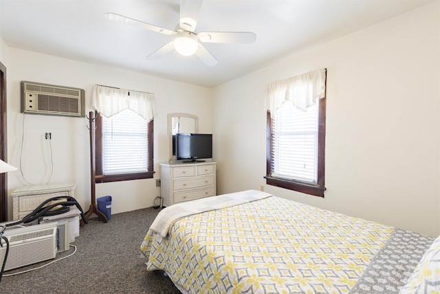 bedroom featuring dark colored carpet, ceiling fan, multiple windows, and a wall mounted AC