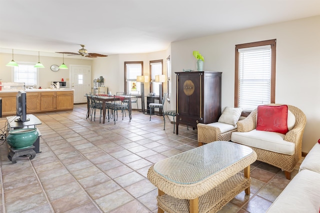 living room featuring light tile patterned floors and ceiling fan