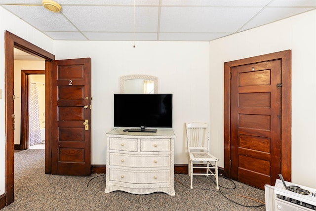 carpeted bedroom featuring a drop ceiling